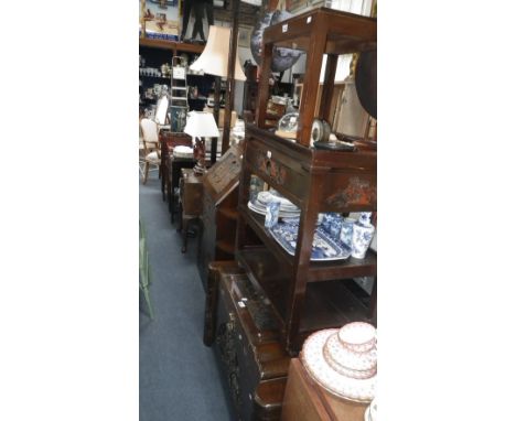 A Chinese style carved hardwood bureau with carved fall and drawers with similar standard lamps, table lamp, side table,  car