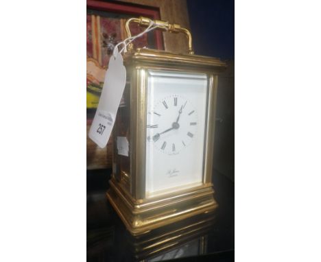 A carriage clock with white enamel dial, signed St James, London
