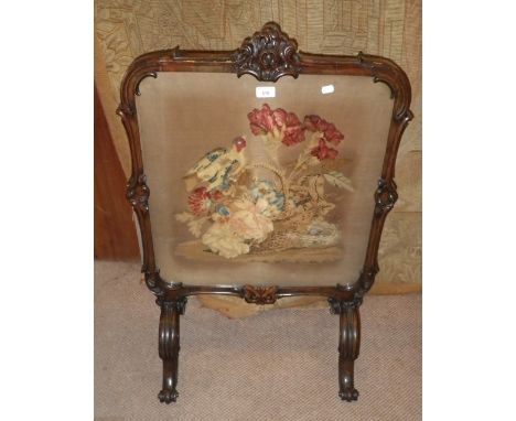 A Victorian rosewood framed fire screen with original needlework panel 