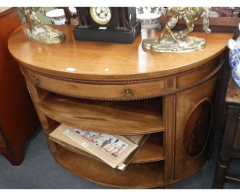 A George III style bowfronted cabinet with an open shelf front between cupboards