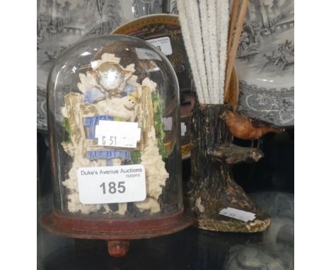 A Victorian ornament of a child by a gate beneath a dome and a similar match holder