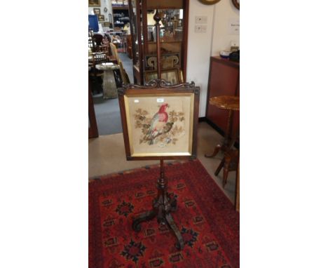 A Victorian rosewood pole screen, the screen with inset needlework panel depicting a parrot  