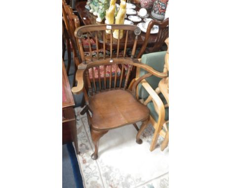A reproduction 18th century American style walnut armchair with solid seat and cabriole legs