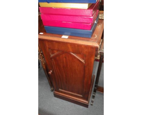 A Victorian mahogany bedside cabinet with single panel door on plinth base