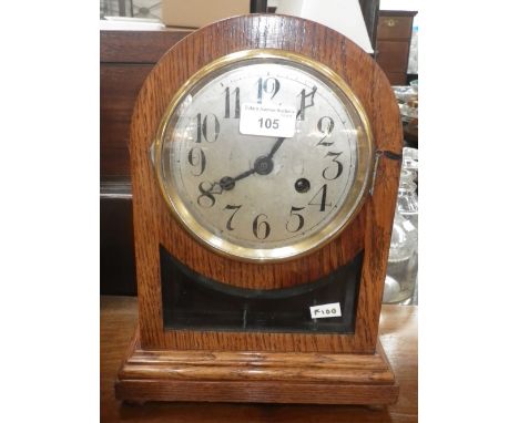 An early 20th century oak cased mantel clock with silvered dial, 12.75" high