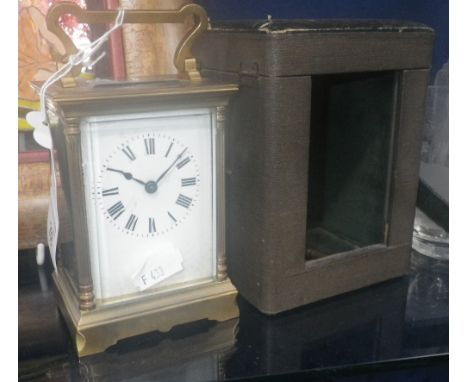 A brass-cased carriage clock and case