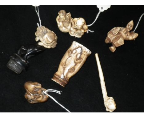 Three 19th century Japanese carved ivory Netsukes, one carved wood Netsukes a carved horn vessel and a small carved ivory pip