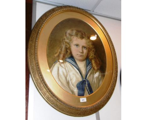 A late Victorian watercolour portrait of a child in a sailor suit, in an oval gilt frame