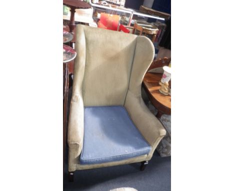 An Edwardian wing-back armchair