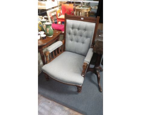 A late Victorian oak framed armchair, upholstered in William Morris style blue material