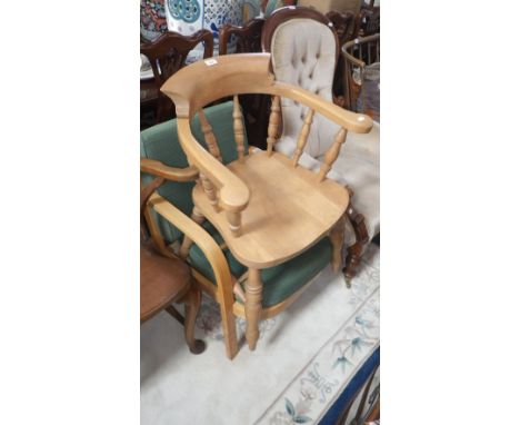 A reproduction Victorian style beech smoker's bow and a contemporary armchair with loose cushions