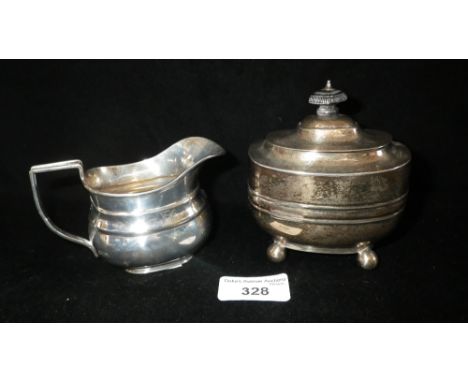 A Georgian style Victorian silver tea caddy with hinged lid and a similar cream jug (2)