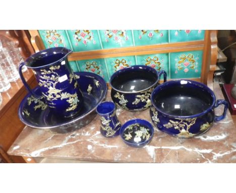 A Bursley ware pottery wash jug and basin, two chamber pots, soap dish and vase with Japanese decoration on blue ground (6) 