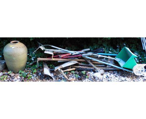 A terracotta garden vase, a mortar and a quantity of garden tools.