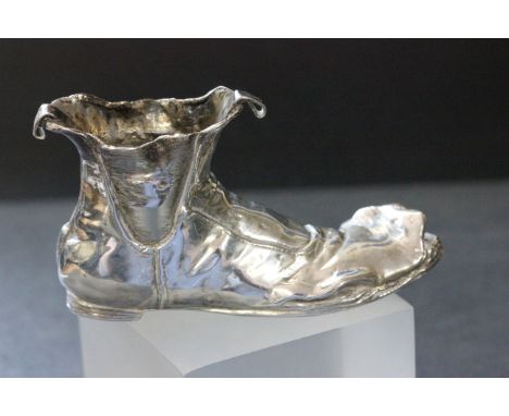 A silver model of old boot with a mouse hiding in the front, Chester import marks