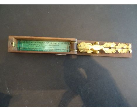 A set of early 20th century sovereign and half sovereign weighing scales  