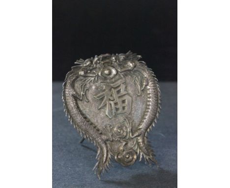 An early 20th century Chinese silver card holder, decorated with dragons chasing a flaming pearl 