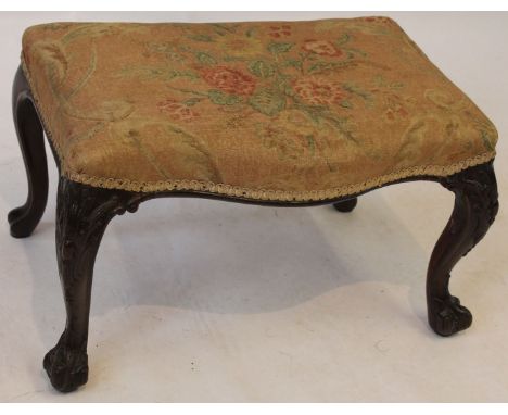 A Chippendale Revival carved mahogany framed dressing stool, 19th Century
The serpentine seat re-upholstered, raised on acant