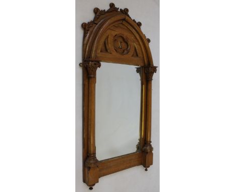 A late Victorian carved light oak framed wall mirror in the Ecclesiastical taste
The lancet arched top with foliate surmount 