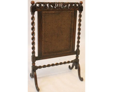 A Carolean revival carved oak firescreen, circa 1920
Featuring a central Bergere panel flanked by barleytwist uprights and co