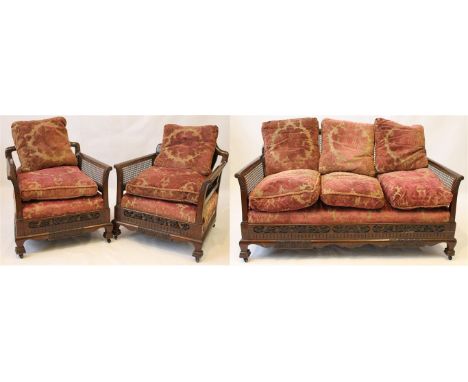 A handsome carved mahogany framed Bergere three piece lounge suite, circa 1920s
Comprising a three seater settee and two armc