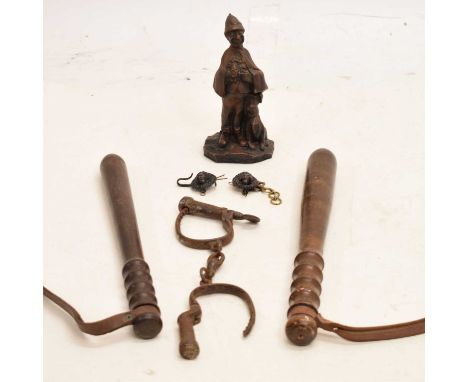 Group of police related items comprises two wooden truncheons with brown leather wrists grips, pair of handcuffs, lion mask c