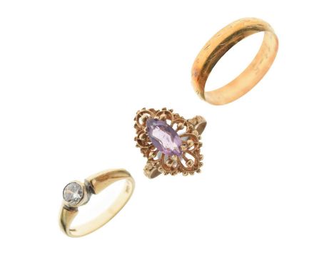 Three 9ct gold rings comprising a 9ct gold cubic zirconia solitaire ring, size L approx, a 9ct gold filigree ring set purple 