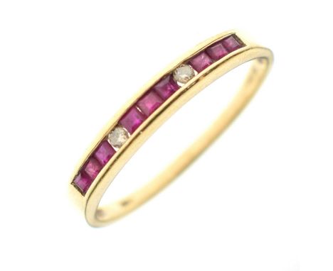 Ruby and diamond 18ct gold channel set ring, the two round brilliant cut diamonds each set between three sections of three ca