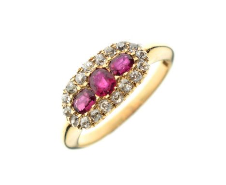 Ruby and diamond cluster ring, the yellow metal shank stamped '18', the three red stones within a border of old cut diamonds,
