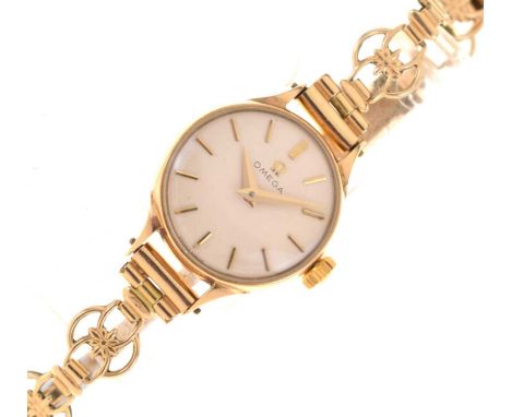 Omega - Lady's 9ct gold cased bracelet watch, the silvered dial with applied gilt baton hour markers and gilt dauphine hands,
