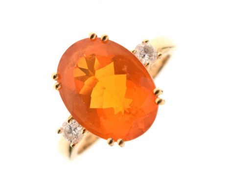 Fire opal and diamond three-stone ring, the large faceted oval opal measuring 10mm x 13mm approx, the two diamonds 0.10ct app