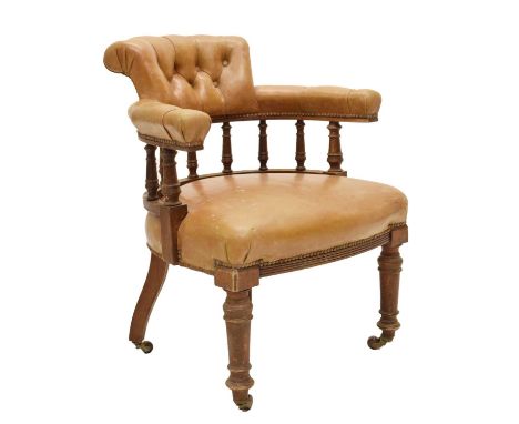 Early 20th century brown leatherette button upholstered smoker's bow-type chair, on two turned front supports, raised on cast