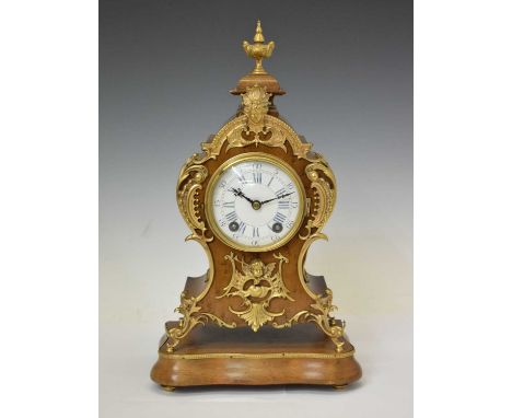 Early 20th century Lenzkirch French-style mantel clock with gilt metal mask and foliate scroll decoration, the white enamel d
