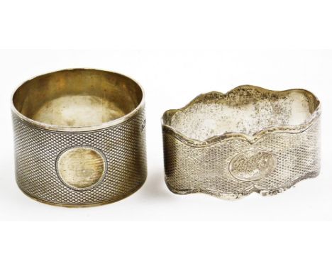 A George V silver napkin ring, of cylindrical form, engine turned with plain cartouche, 4cm diameter, Sheffield 1933, and ano