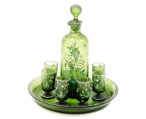 A Continental enamelled green glass liquor decanter and six glasses, on a circular tray, 20cm diameter. Upon initial inspecti