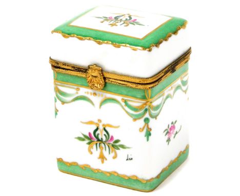 A Limoges porcelain trinket jar, with green enamelled decoration picked out in gilt with flowers, on a lift up acanthus shelf