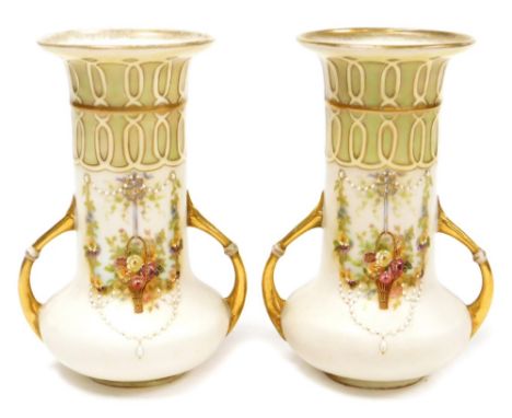 A pair of Amphora style sleeve vases with handles, with gilt decoration and floral painted garlands with applied pearl decora
