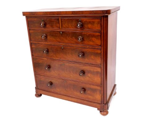 A Victorian flame mahogany chest, of two short and four graduated drawers, with knob handles having mother of pearl centres, 