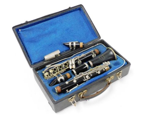 A Champion clarinet, with reed and mouth piece, in a fitted case. 