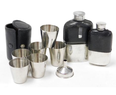 Two late 20thC hip flasks, each with stainless steel covering and black leather sleeve, one stamped Made in England, 1½ oz, w
