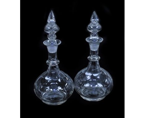 A pair of early 19thC balloon glass decanters, each with elaborate finial stopper, the bodies with engraved oval dome design,