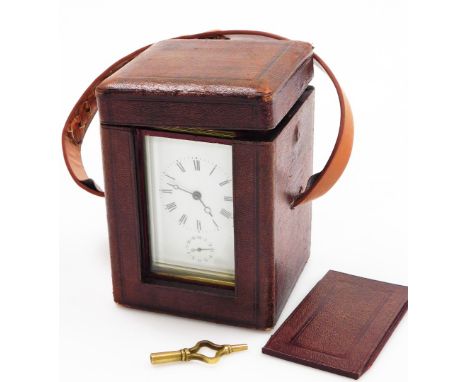An early 19thC brass carriage timepiece, with white enamel dial with seconds dial in brass casing, the handle (AF) in a brown