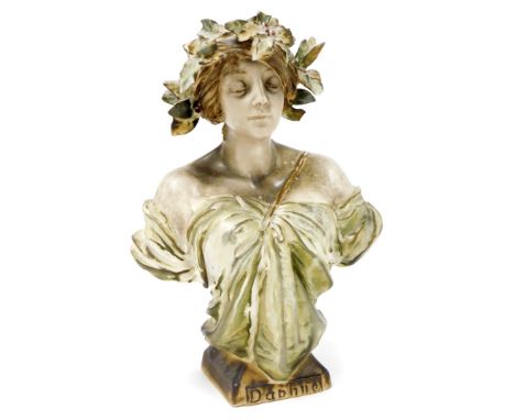 An Amphora porcelain Art Nouveau bust of Daphne by Ernst Wahliss, depicting a young maiden with leaves in her hair and wearin