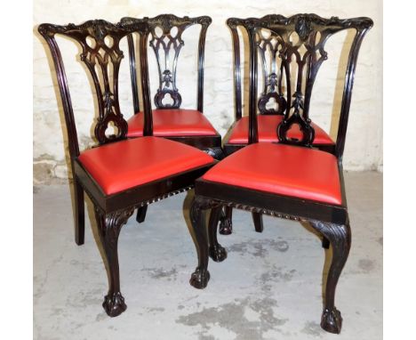 A set of four 20thC mahogany Chippendale style dining chairs, each with comb cresting rails, in pierced back splats and carve