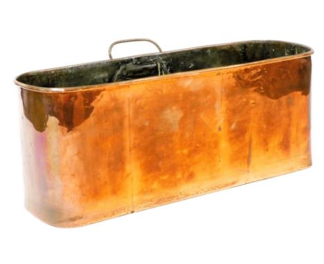 A Victorian copper planter, oval with retractable loop handle, 19cm high, 49cm wide, 18cm deep.