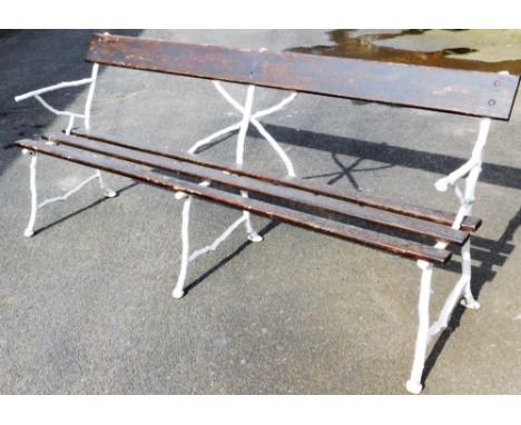 A large Victorian rustic cast iron garden bench,painted in white with slatted seat and back, 91cm high, 200cm wide. 