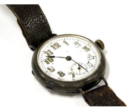 An early 20thC silver cased wristwatch, with small white enamel dial with green painted numbers, in a silver casing, on a bro
