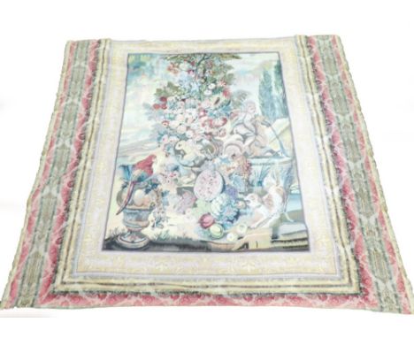 An early 20thC tapestry, depicting parrot, fruit, vines and dog within a fleur de lis border and extended gammer scene border