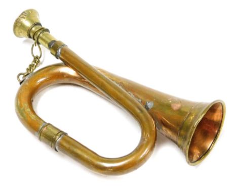 A miniature brass bugle, 15cm wide.