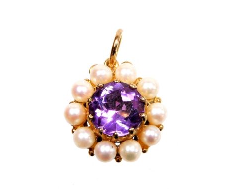 A 9ct gold amethyst and seed pearl floral pendent, the central amethyst stone in core setting surrounded by seed pearls, in a